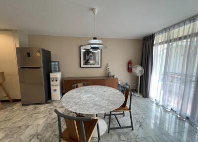 Modern dining area with marble table and floor-to-ceiling windows