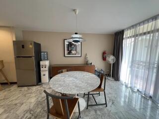 Modern dining area with marble table and floor-to-ceiling windows