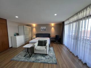 Spacious bedroom with modern furnishings and natural light