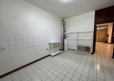 Empty kitchen with tiled walls