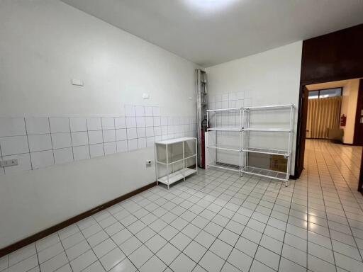 Empty kitchen with tiled walls