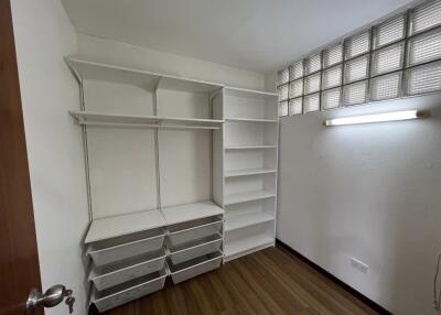 Storage room with shelving units and storage bins