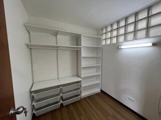 Storage room with shelving units and storage bins