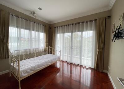 Bright bedroom with large windows and daybed