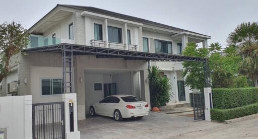 Two-story house with covered parking and landscaped yard