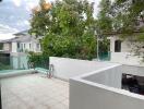 View from balcony with tree and neighboring buildings