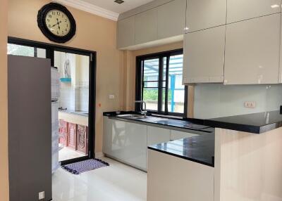 Modern kitchen with glossy cabinets and black countertops