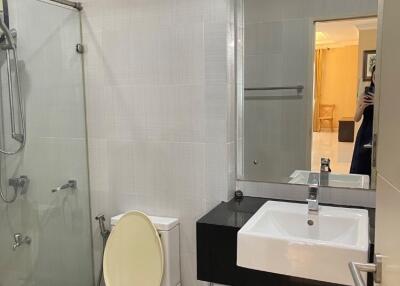 Modern bathroom with glass shower and wall-mounted sink