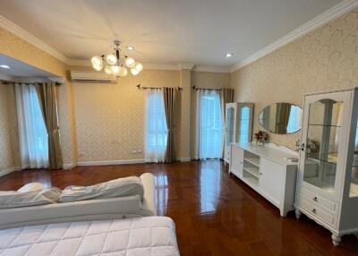 Spacious bedroom with wooden flooring and elegant furnishings