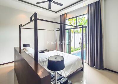 Modern bedroom with a canopy bed and large windows