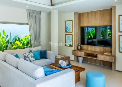 Modern living room with large sectional sofa and wall-mounted TV