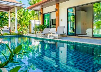 Luxury outdoor area featuring a pool with loungers adjacent to the house