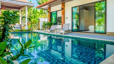 Luxury outdoor area featuring a pool with loungers adjacent to the house