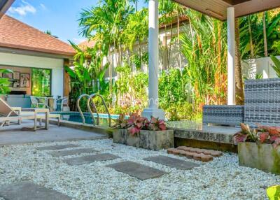 Beautifully landscaped backyard with pool and seating area