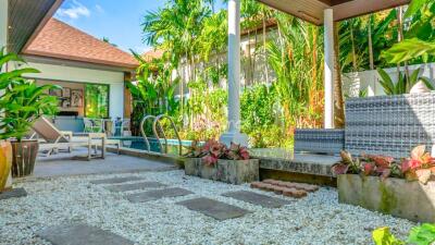 Beautifully landscaped backyard with pool and seating area