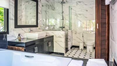 Modern bathroom with marble tiles and glass shower