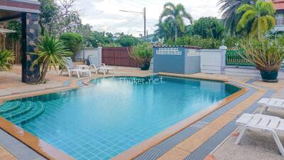 Outdoor swimming pool area with surrounding lounge chairs