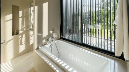 Modern bathroom with bathtub and large window