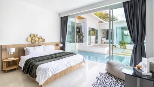 Spacious bedroom with a view of the pool and garden