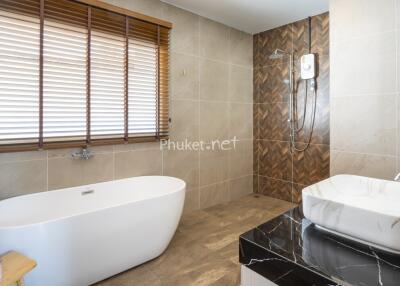 Modern bathroom with a bathtub, sink, and shower