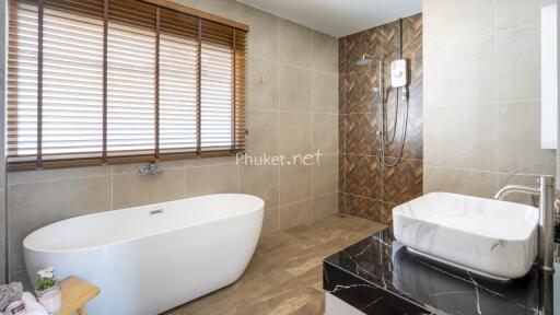 Modern bathroom with a bathtub, sink, and shower