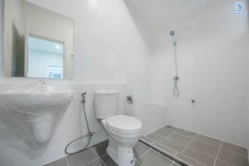 Bright bathroom with shower, toilet, and sink