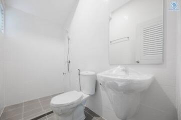 modern white bathroom with toilet and sink