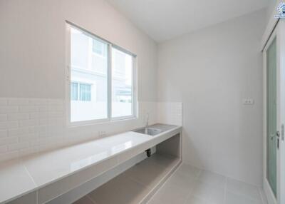 Bright minimalist kitchen with large window and sleek countertop