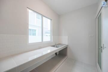 Bright minimalist kitchen with large window and sleek countertop