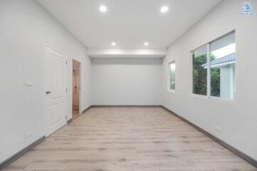 Spacious living room with modern lighting and large windows