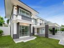 Modern two-story house exterior with lawn and covered driveway