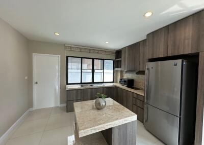 Modern kitchen with wooden cabinets and marble countertops