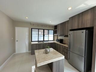 Modern kitchen with wooden cabinets and marble countertops