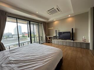 Modern bedroom with large windows and balcony view