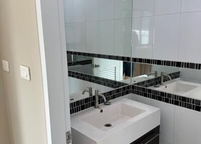 Modern bathroom with stylish vanity and large mirror