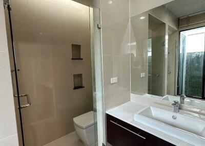 Modern bathroom with glass shower and large mirror