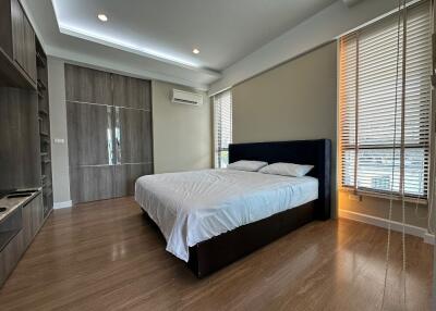 Modern bedroom with wooden flooring and large bed