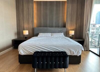 Spacious modern bedroom with large bed and accent wall