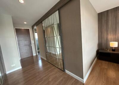 Modern hallway with wooden flooring and mirrored closet