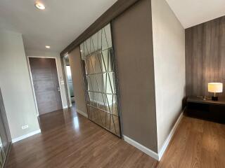 Modern hallway with wooden flooring and mirrored closet