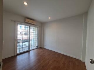 Living room with wooden flooring and large windows