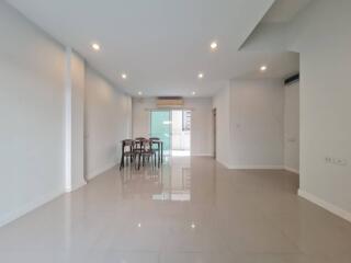 Spacious living room with dining area and large windows