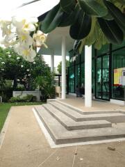 Outdoor view of a building entrance with steps and glass windows