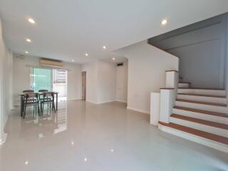 Spacious living room with dining area and staircase