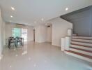 Spacious living room with dining area and staircase