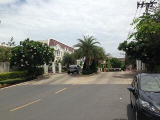 Residential complex with parked cars and greenery