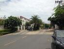 Residential complex with parked cars and greenery