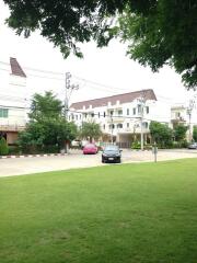 View of residential buildings from across a lawn