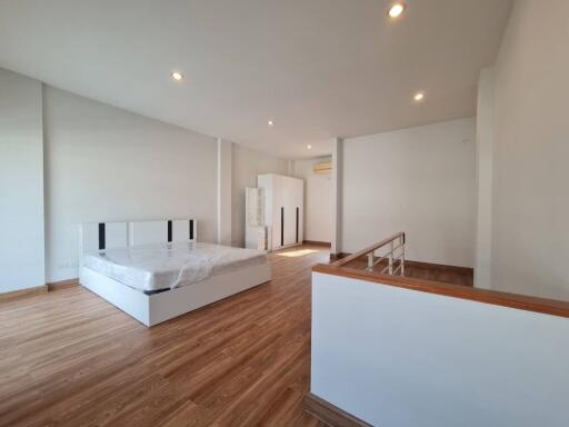 Spacious modern bedroom with wooden flooring