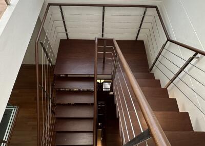 Modern wooden staircase with metal railing